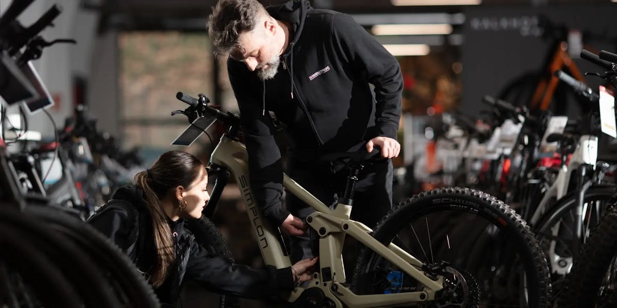 Blick in die Werkstatt der Fahrradprofis wo ein Mann und eine Frau an einem Fahrrad arbeiten. In dieser Case Study erfährst du, wie die Fahrradprofis mit dem Xentral ERP neue Wege erschließen! 
